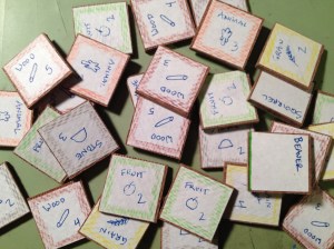 Wood tiles with hand drawn icons and colored pencil edges. Wow.